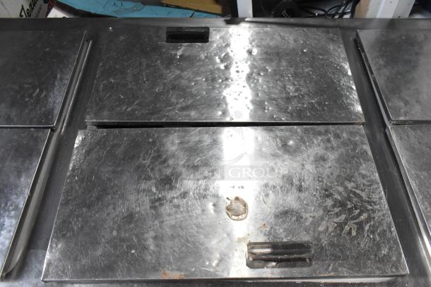 Excellence HFF-12-HC commercial chest freezer with three center hinge lids, visible wear, 115 volts, 1 phase.