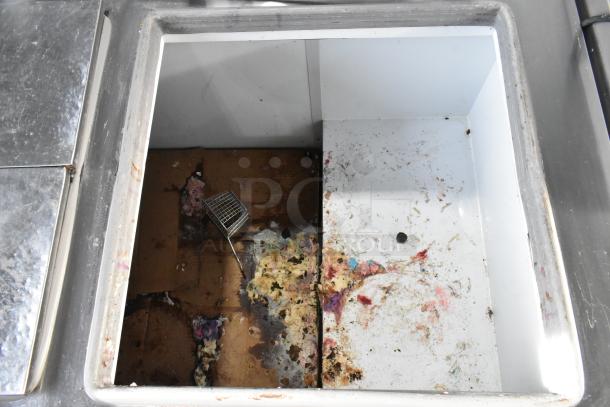 Excellence HFF-12-HC commercial chest freezer with 3 center hinge lids, visible wear and stains, 115 volts, 1 phase.