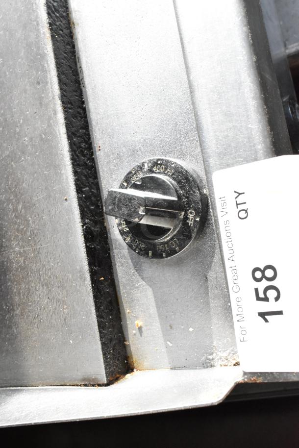 Bakers Pride commercial gas griddle knob; silver surface, temperature markings; item tag 158 visible.