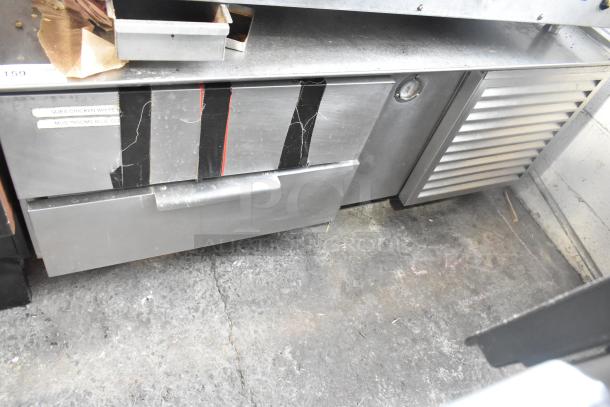 Commercial 2 Drawer Chef Base, stainless steel, visible wear with taped labels, sturdy construction.