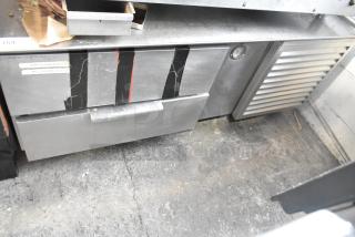 Commercial 2 Drawer Chef Base, stainless steel, visible wear with taped labels, sturdy construction.