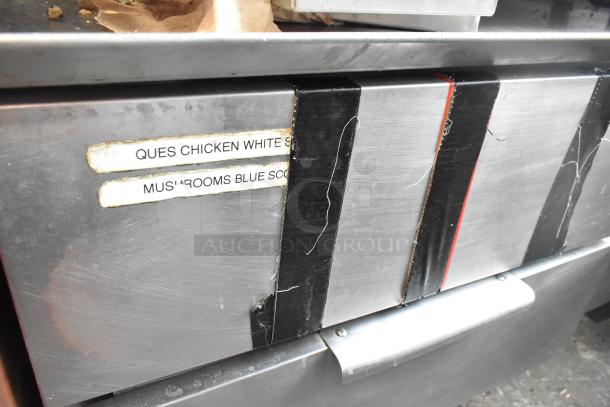 Commercial 2 Drawer Chef Base, stainless steel, labeled compartments, visible wear, ideal for restaurant kitchens.
