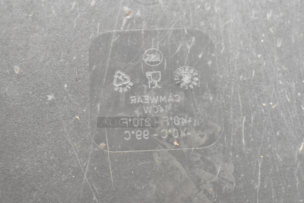 Close-up of commercial chef base with two drawers, scratched surface, and visible manufacturing stamps indicating temperature range and material type.
