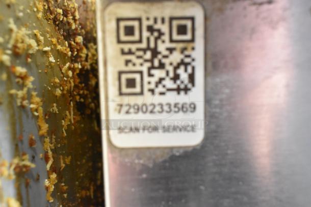 QR code for service on Delfield UC4048P-STAR Cooler, model and condition not clearly visible. Rust and corrosion present.
