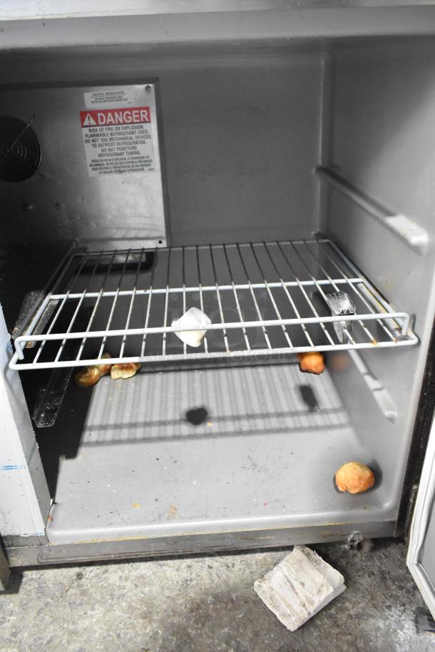 2021 Delfield UC4048P-STAR 2 Door Undercounter Cooler interior. Contains shelf and warning label. Visible wear.