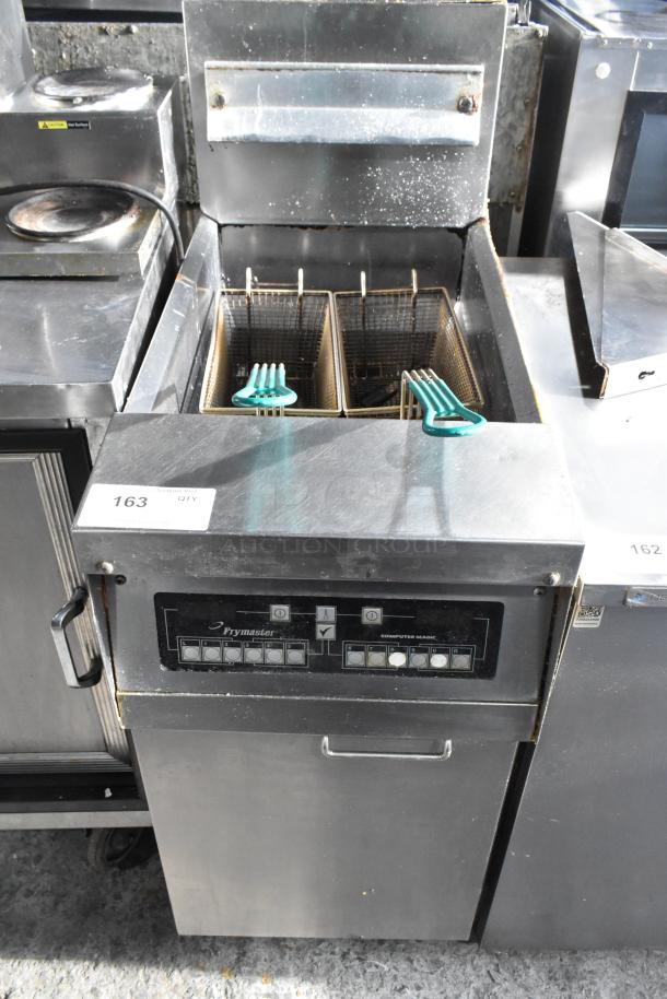 Frymaster commercial floor fryer with two metal fry baskets, control panel, and stainless steel body. Used condition.