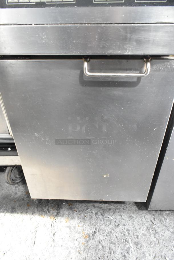 Frymaster commercial floor fryer with two metal fry baskets. Stainless steel, moderate wear, suitable for restaurants.