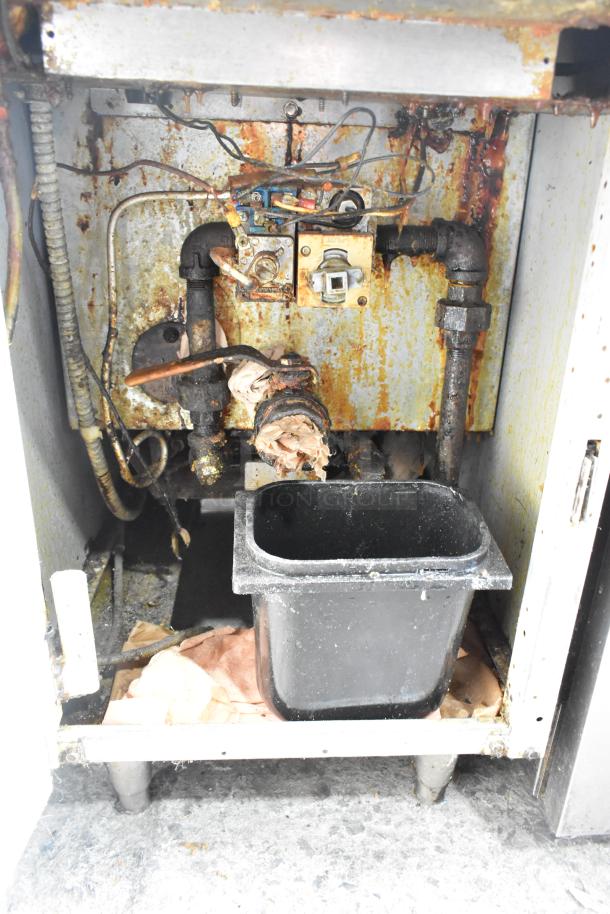 Frymaster Commercial Floor Fryer with pipes and components exposed, shows wear and rust, includes two metal fry baskets.