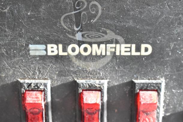 Bloomfield 8571 countertop coffee machine with 3 burners, 120 volts, 1 phase; visible wear and red switches.