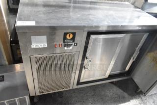 Commercial 2 Door Undercounter Cooler with stainless steel finish, vented front panel, and label for covered food. Good condition.