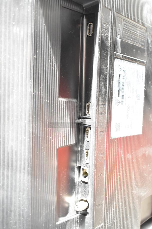 Samsung BE43D-H 43" TV rear ports; features HDMI, USB, and Ethernet connections. Labels show power info, no shipping.