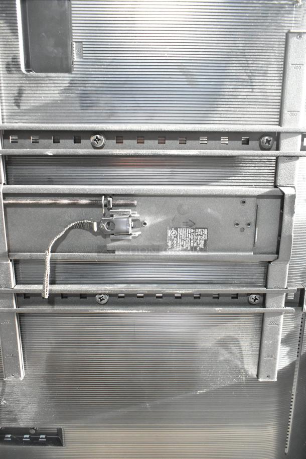 Samsung BE43D-H 43" TV back view, showing mounting system and serial label. 110-127V, local pickup only.