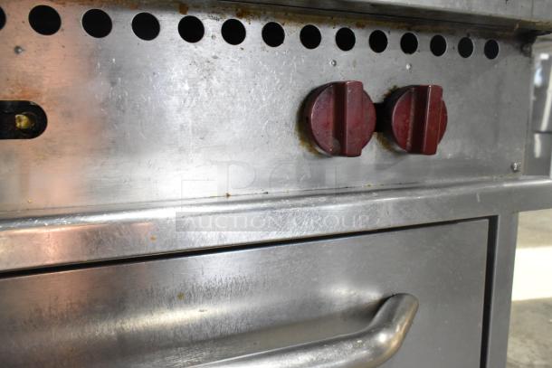 Vulcan commercial gas-powered range with 6 burners, oven, backsplash, and overshelf. Visible wear on control panel.