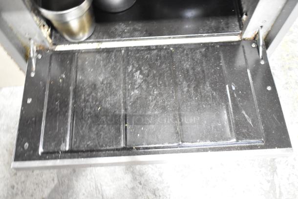 Vulcan commercial 6-burner range with oven; features over shelf, backsplash, visible wear on oven door panel.