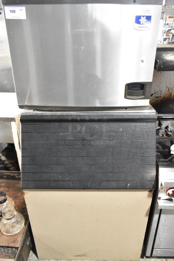 Manitowoc commercial ice machine head on black ice bin, stainless steel, model label visible, good condition.