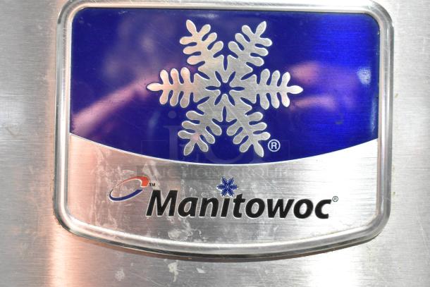 Manitowoc Commercial Ice Machine Head logo on stainless steel surface, with trademark snowflake design.