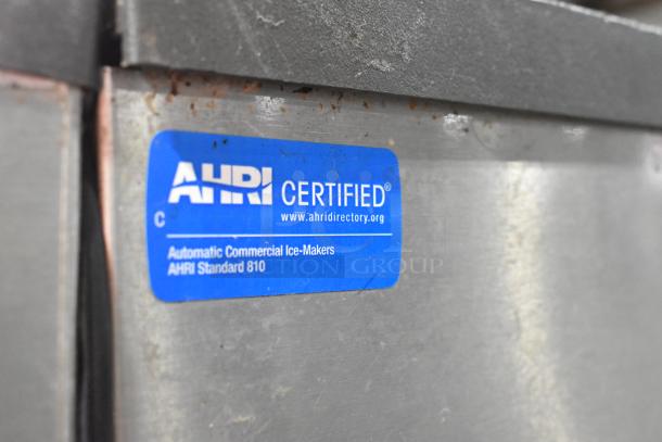 Manitowoc commercial ice machine head on bin, AHRI certified, label indicates compliance with AHRI Standard 810.