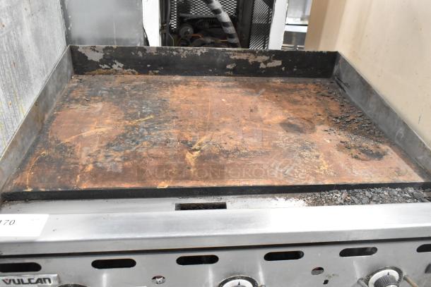 Vulcan PSA36-101 natural gas flat top griddle, 81,000 BTU. Visible wear, rust on cooking surface. Ideal for commercial use.