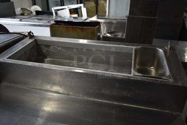 Migali commercial pizza prep table, stainless steel, used condition, 115 volts, 1 phase, spacious interior layout.