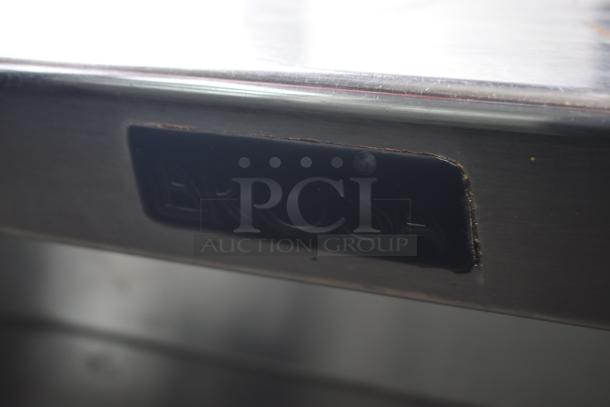 Commercial prep station with stainless steel surface and "AROSA" marking, mounted on commercial casters for mobility.