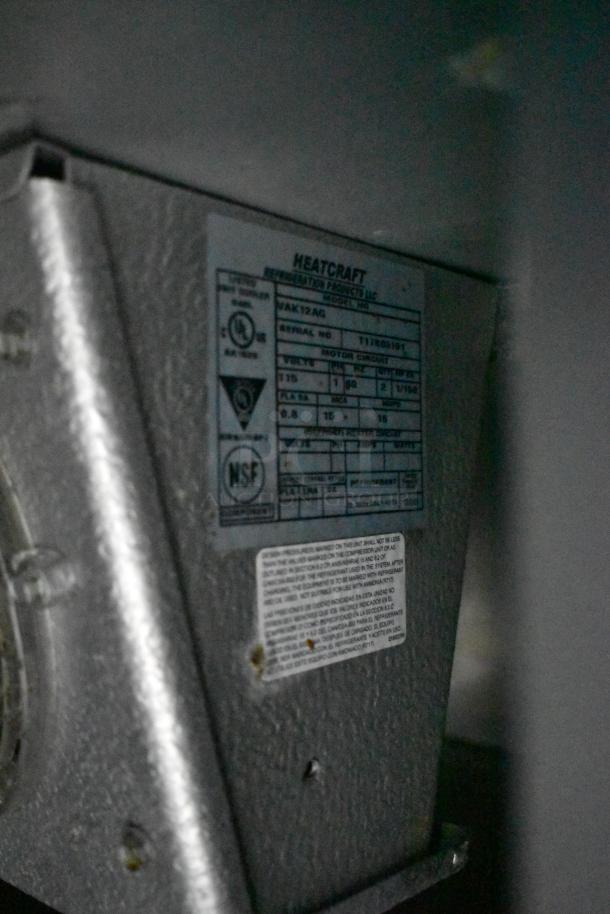 Commercial prep station with Heatcraft refrigeration unit. Features NSF certification, model MAK12AG. Mounted on durable commercial casters.