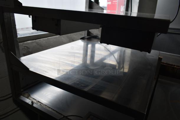 Commercial multi-shelf merchandiser display with warming strips, featuring sturdy metal shelves and heating element overhead.