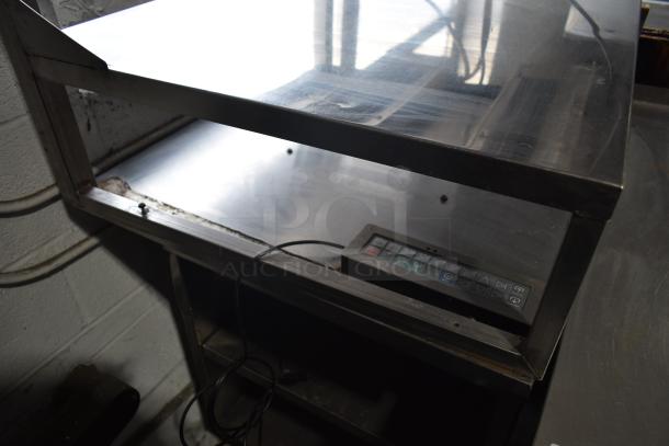 Commercial multi-shelf merchandiser display with warming strips in fair condition. Features control panel, stainless steel build.