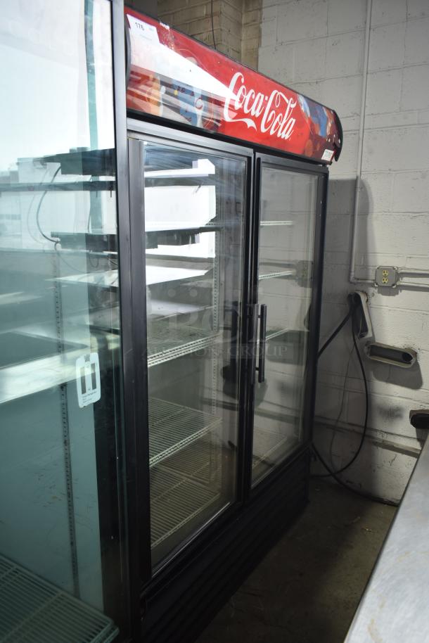 True GDM-49 commercial cooler, 2 glass doors, Coca-Cola branding, 115 volts, 1 phase, shelves inside, used condition.