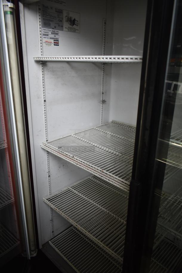 True GDM-49 Commercial 2 Door Reach-In Cooler, 115V, 1 Phase, shelves visible, interior labels shown.