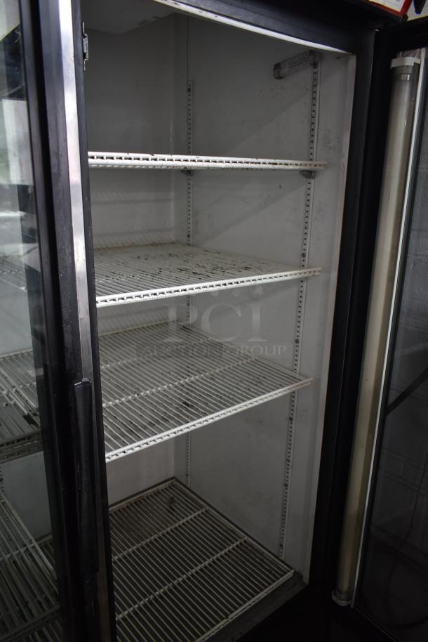 True GDM-49 Commercial 2 Door Reach In Cooler. White interior, shelves, some visible wear. 115V, single phase.