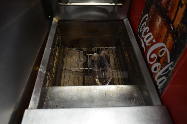 Frymaster PH155CSD commercial fryer, natural gas, 105,000 BTU, includes 2 metal baskets. Visible wear and grease marks.