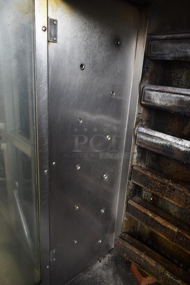 Hobart HGR06 commercial rotisserie oven interior, stainless steel with visible wear, gas control rods and mounting bolts shown.