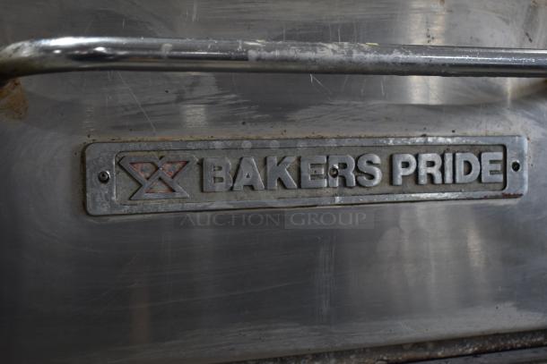 Bakers Pride commercial gas powered single deck pizza oven, stainless steel, visible wear, Bakers Pride logo on front.