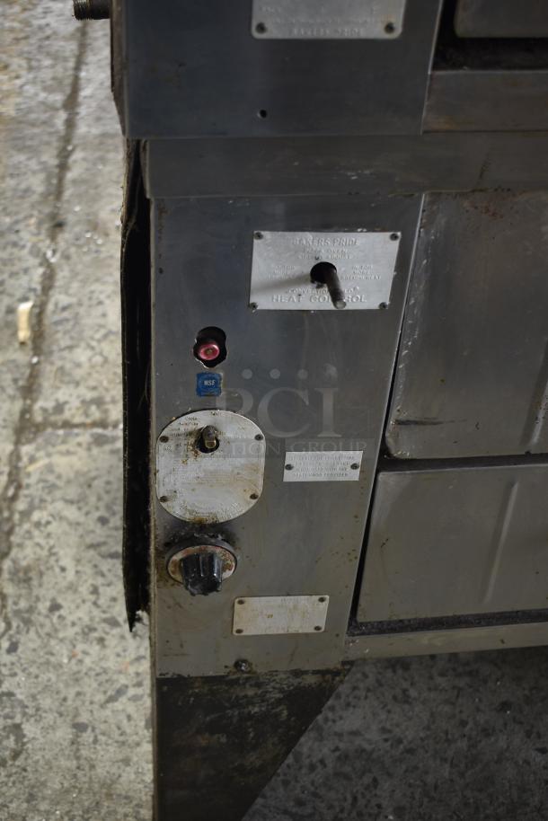 Bakers Pride commercial gas pizza oven, single deck, visible wear, NSF certified, heat control knobs and labels shown.