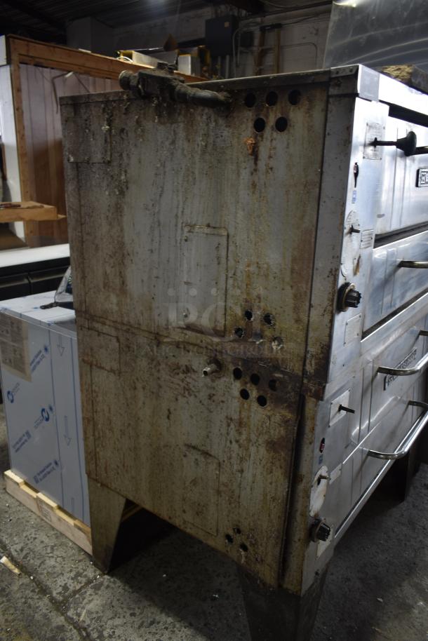 Bakers Pride commercial gas pizza oven, single deck, worn condition, visible rust and dirt, sturdy handles and control knobs.