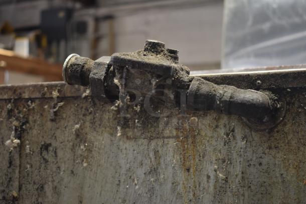 Bakers Pride commercial gas pizza oven part, showing a worn, rusty connector atop a heavily used metal surface.
