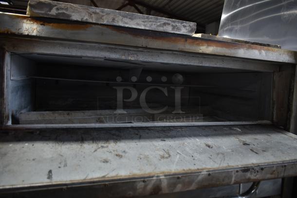 Bakers Pride commercial gas single deck pizza oven, used condition, metal exterior with signs of wear.