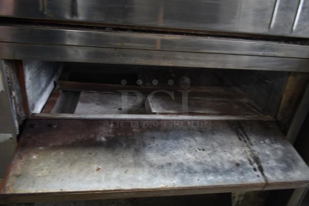 Bakers Pride commercial gas-powered single deck pizza oven, stainless steel, used condition, interior view.