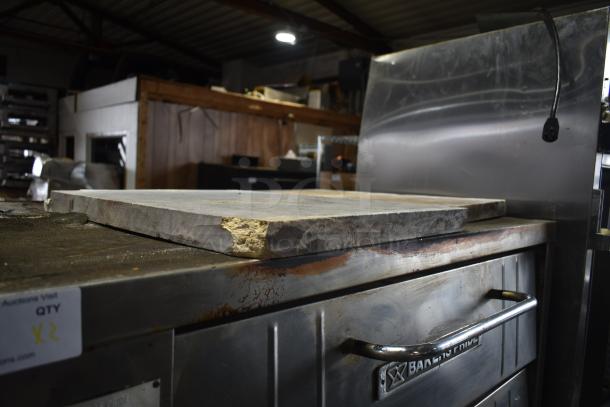 Bakers Pride commercial single deck pizza oven, gas powered, stainless steel, visible wear on stone surface, auction label marked "x2".