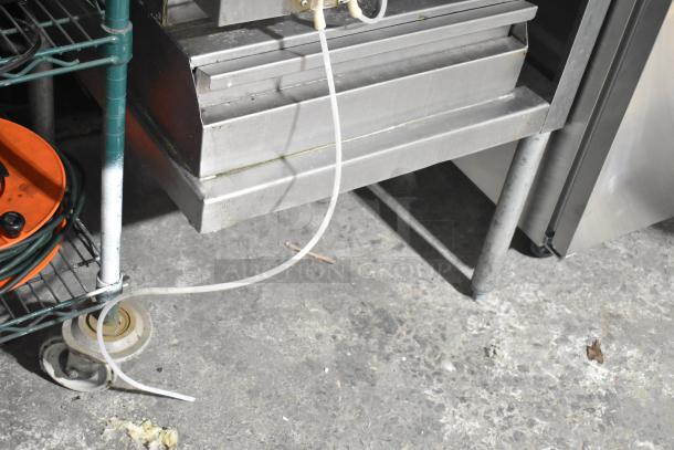 CMA Energy Mizer VA-AH-2 commercial pass-through dishwasher, stainless steel, 120V, 1 phase, showing lower section and plumbing.