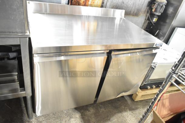Brand new Avantco 178SSWT48FHC commercial 2-door undercounter freezer with casters, slight dent, stainless steel finish.