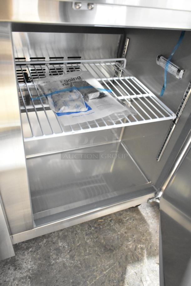 Brand new Avantco 178SSWT48FHC undercounter freezer with commercial casters, 2 doors, 115 volts, 1 phase. Visible internal shelving and packaging.