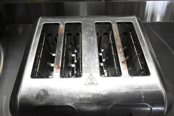 Hamilton Beach 24714G 4-Slot Toaster, stainless steel, 120V. Visible wear and rust spots on slots; caution symbol present.