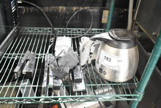 Auction lot with a stainless steel coffee pot, credit card reader, staplers, and metal bracket on a shelf. Tag reads "PCI Auctions, 193 Qty." Mixed condition.