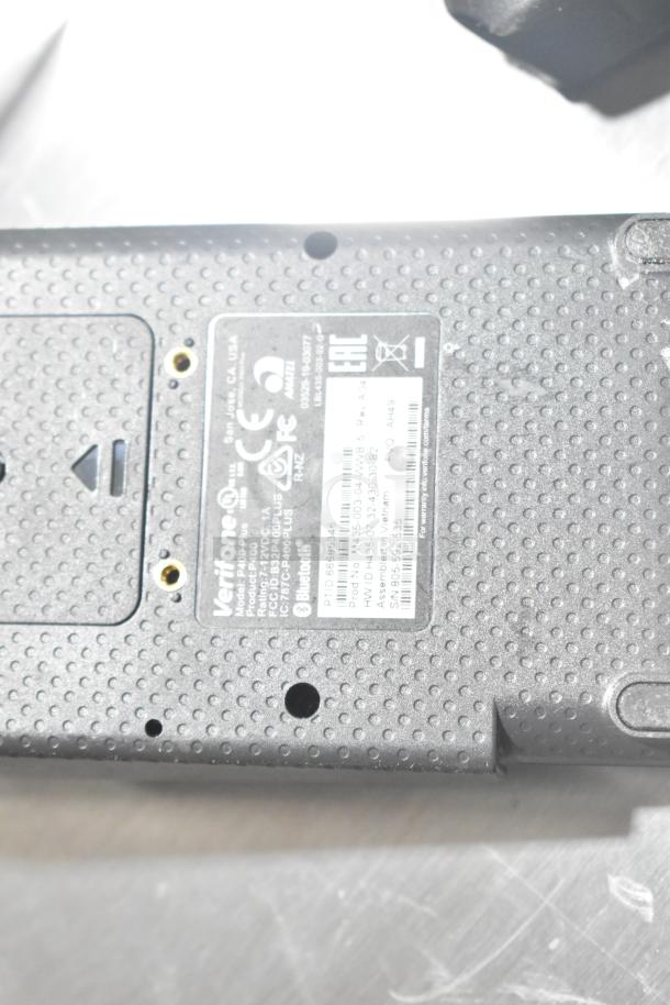 Verifone credit card reader, model P200, with visible labels and markings indicating specifications and certifications.