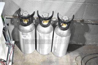 Three silver CO2 tanks with black valves, each labeled "194" indicating quantity of three. Buyer pick-up required.