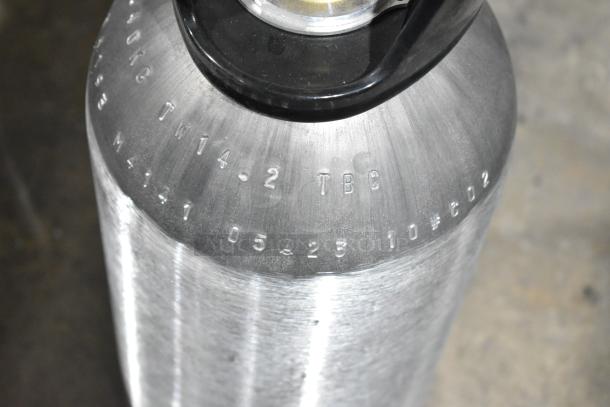 Stainless steel CO2 tank with black handle, embossed markings; part of a lot of 3 tanks available for local pickup.
