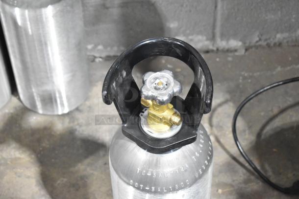 Aluminum CO2 tank with valve, features engravings and a protective handle. Note: buyer must pick up, no shipping.