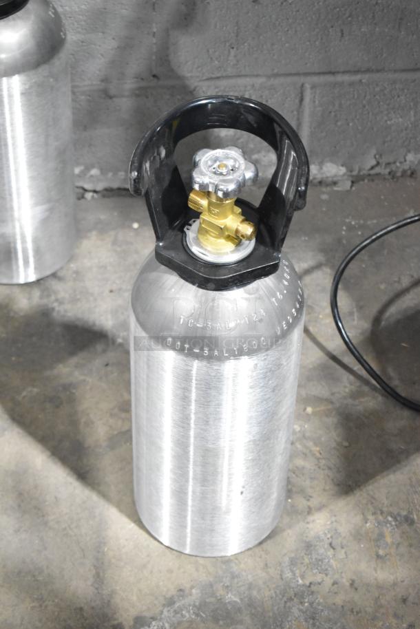 Aluminum CO2 tank with valve, featuring engraved labeling for specs. Tank part of a lot of three, pickup required.