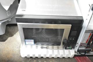 Brand new Amana RC30S2 commercial microwave, stainless steel, push-button controls, 208/240V, USA label, light scratches.